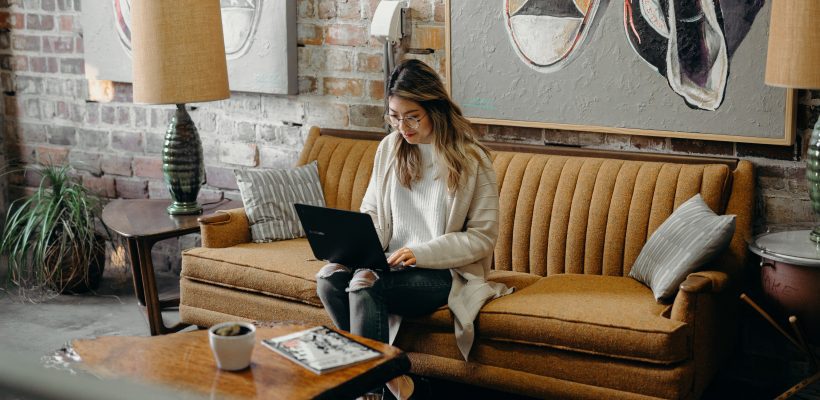 Trendy girl working on her laptop